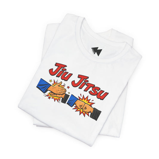 A folded white t-shirt featuring a 'Jiu Jitsu' graphic with two fist-bumping hands in a comic-style illustration, displayed on a clean white background.