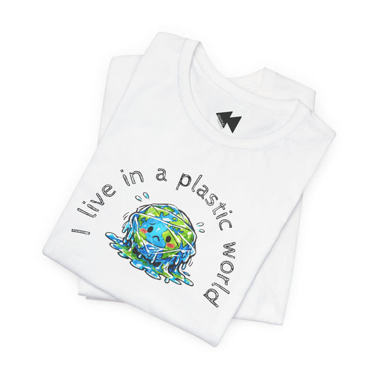 A folded white t-shirt featuring a graphic of a sad, crying blue and green globe with the text 'I live in a plastic world' written in a curved black font around it.