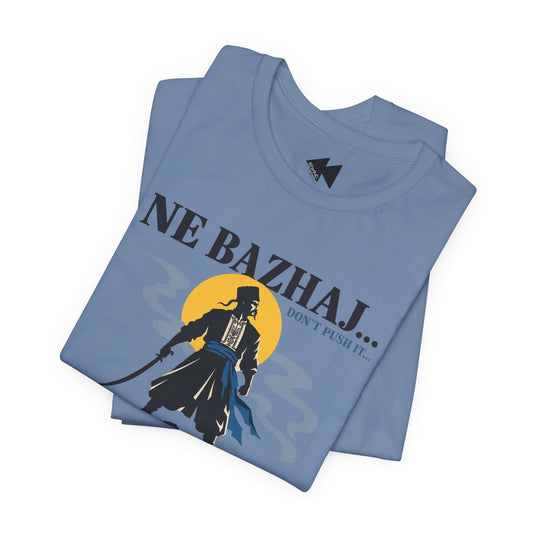 A folded light blue t-shirt featuring a graphic print of a samurai warrior in front of a yellow sun with the text 'NE BAZHAJ.