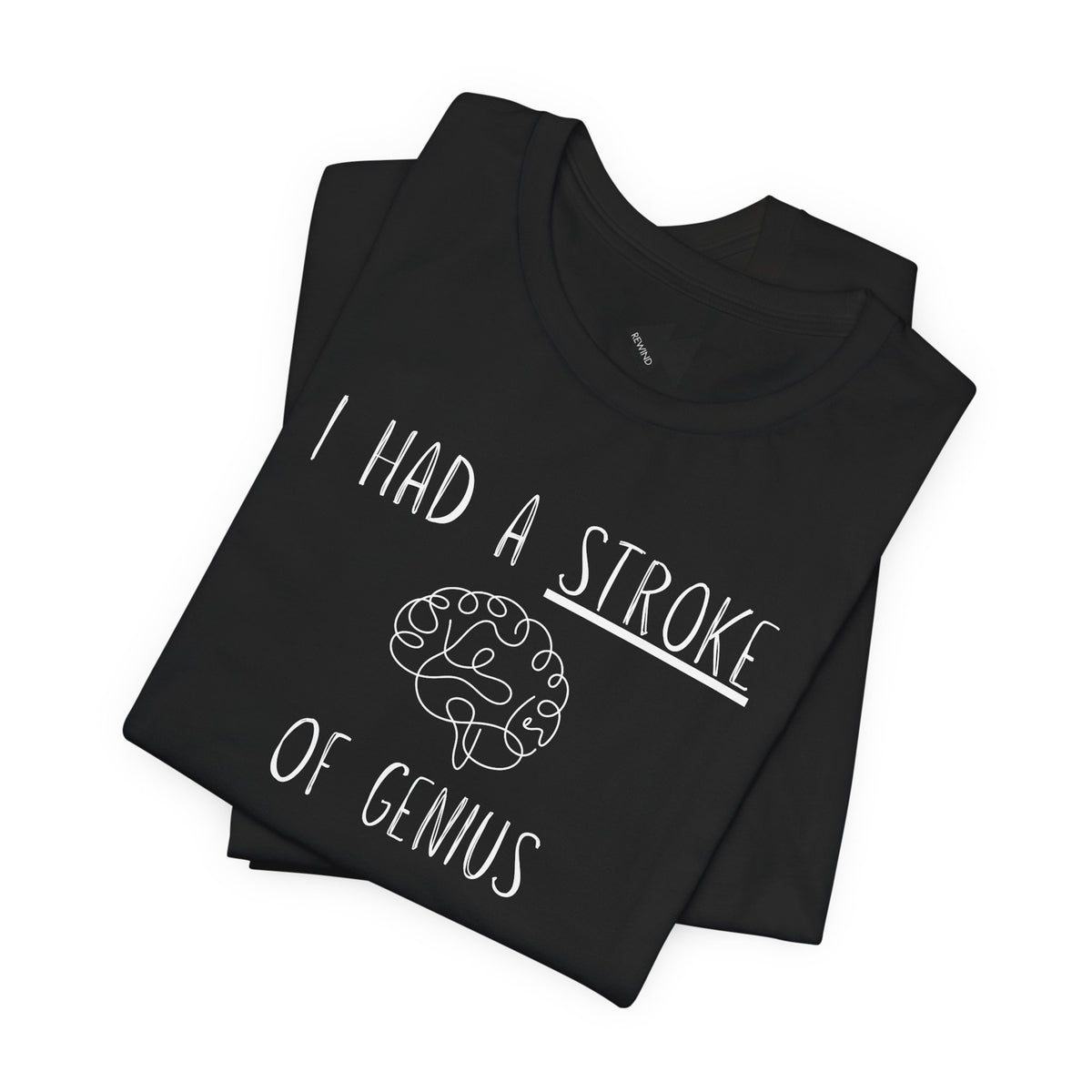 A folded black t-shirt with a black graphic print that reads 'I HAD A STROKE OF GENIUS' surrounding a simple line drawing of a brain. A small black geometric logo is visible inside the collar.