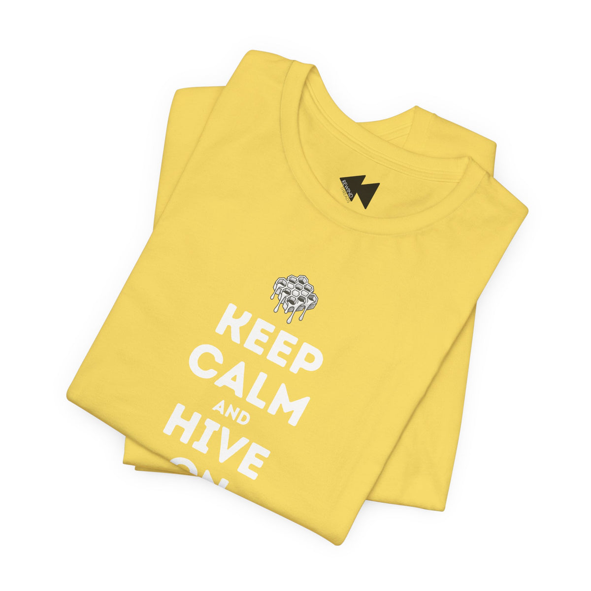 A folded yellow t-shirt with a white 'KEEP CALM AND HIVE ON' text graphic and a dripping bee design, displayed on a clean white background.