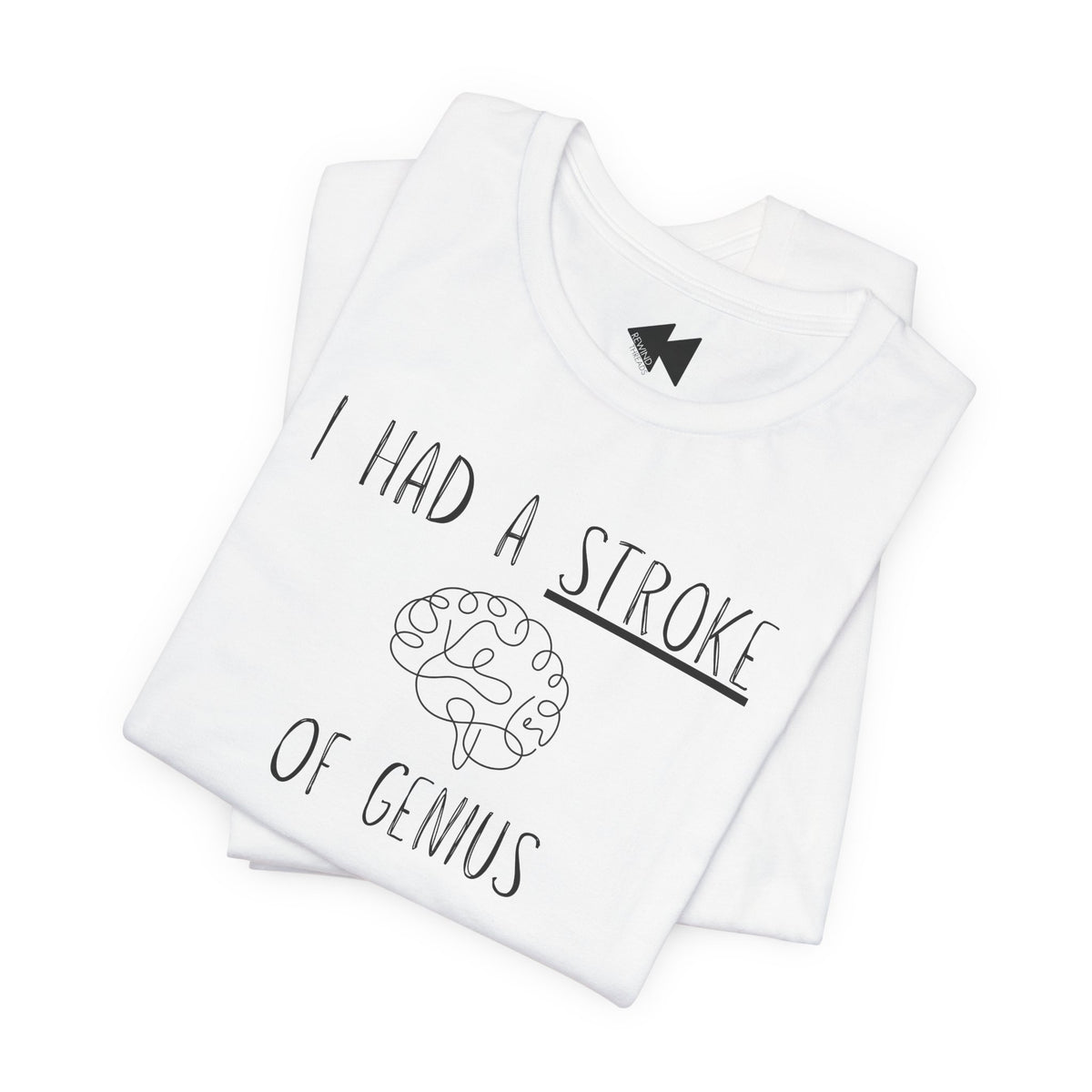 A folded white t-shirt with a black graphic print that reads 'I HAD A STROKE OF GENIUS' surrounding a simple line drawing of a brain. A small black geometric logo is visible inside the collar.
