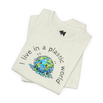 A folded light beige short-sleeve t-shirt with a graphic on the front showing a melting blue and green Earth with the text 'I live in a plastic world' arched above and below it, displayed on a clean white background.