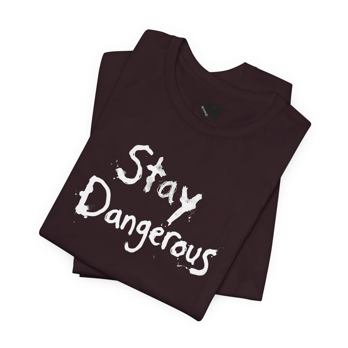 A folded dark maroon t-shirt with the words 'Stay Dangerous' printed in a black distressed brush font on the front, displayed on a clean white background.