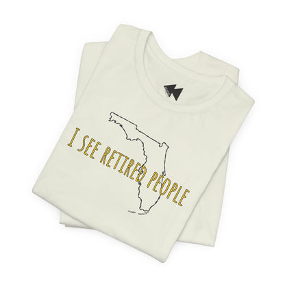 A folded citron green t-shirt with a graphic of the state outline of Florida and the text 'I SEE RETIRED PEOPLE' in gold, displayed on a clean white background.
