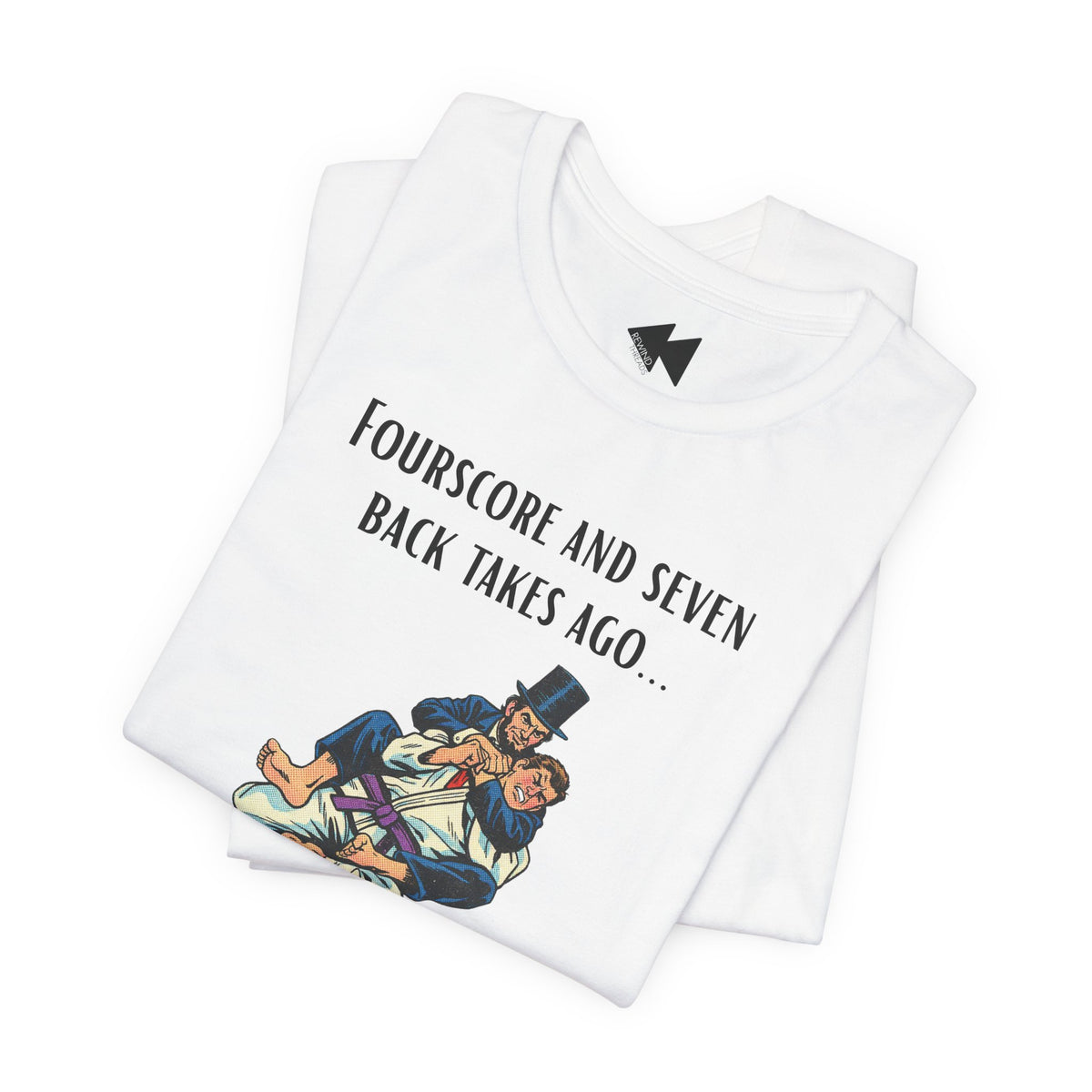 A folded white t-shirt with a black graphic print that reads 'Fourscore and Seven Back Takes Ago.