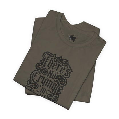 A folded army color short-sleeve T-shirt with a black gothic-style graphic text print reading 'There's No Crying in JiuJitsu' on the front, displayed against a clean white background.