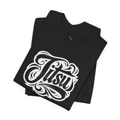 A folded black t-shirt with a large white stylized graphic reading 'Jitsu' on the front, displayed on a clean white background.