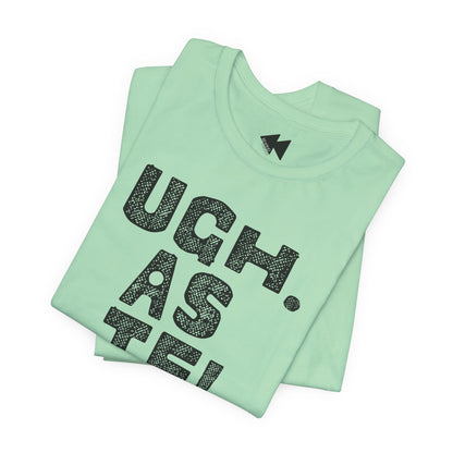 A folded mint green t-shirt with a black textured graphic reading 'UGH. AS IF'.