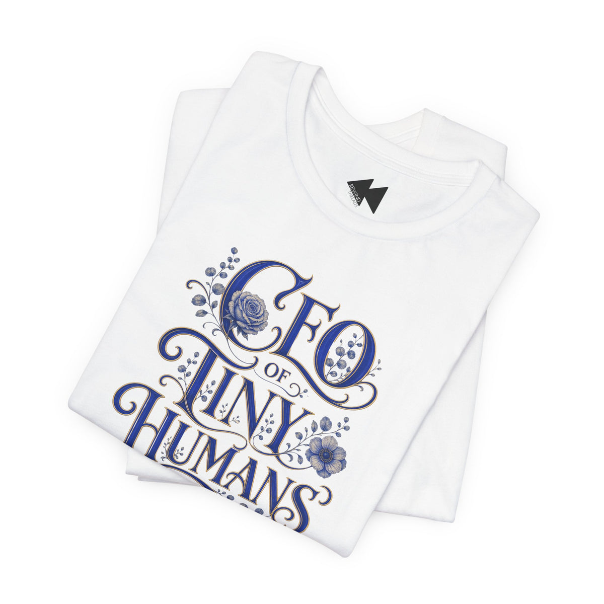 A folded white t-shirt with a blue graphic print that reads 'CEO of TINY HUMANS' in an ornate script with floral details, set against a plain white background.