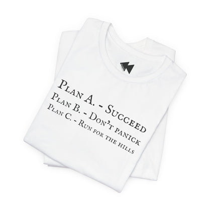 A folded white t-shirt short-sleeve crewneck with black printed text on the front reading 'PLAN A. - SUCCEED PLAN B. - DON'T PANICK PLAN C. RUN FOR THE HILLS'