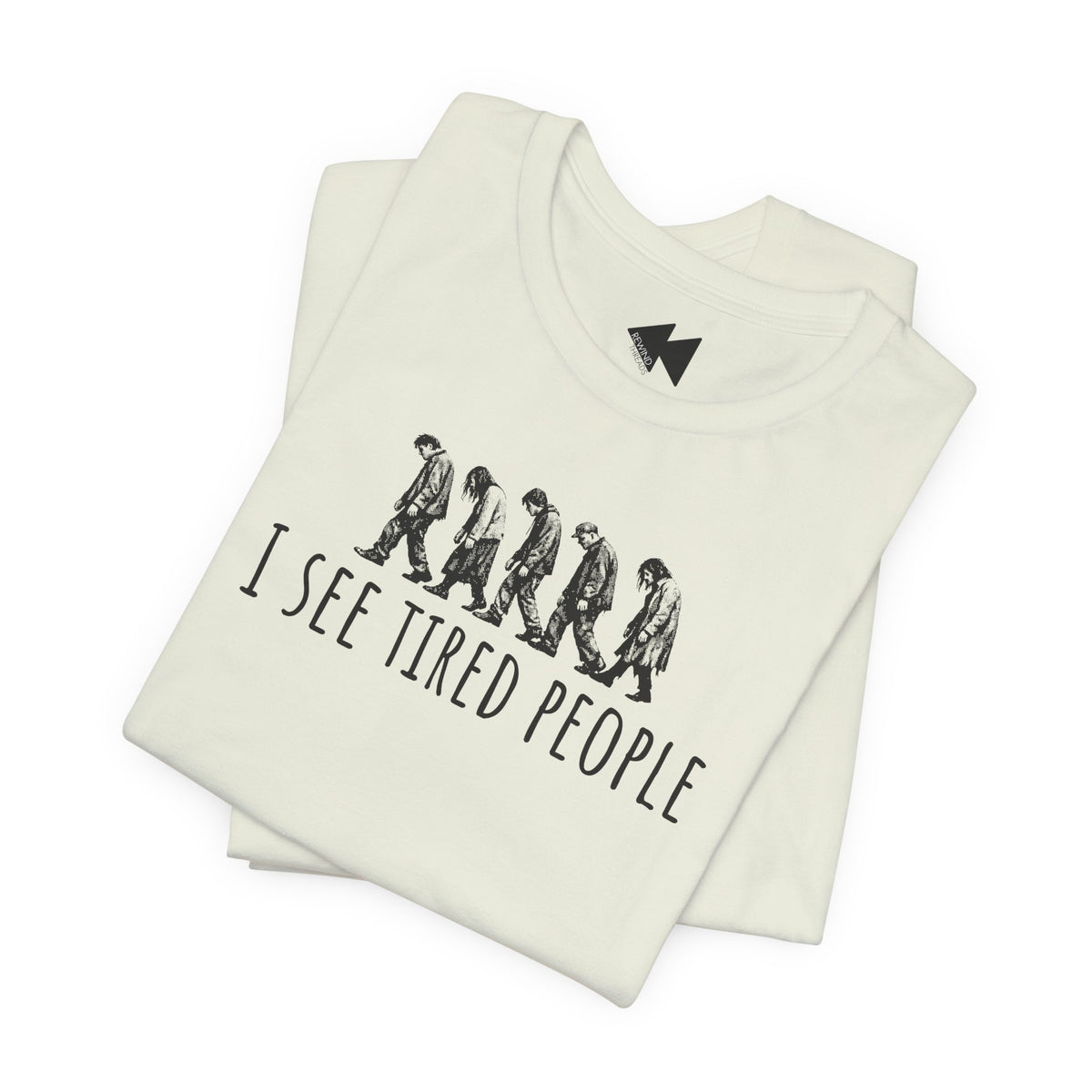 A folded off-white t-shirt with a black graphic of six walking figures and the text 'I SEE TIRED PEOPLE' printed on the front, set against a plain white background.