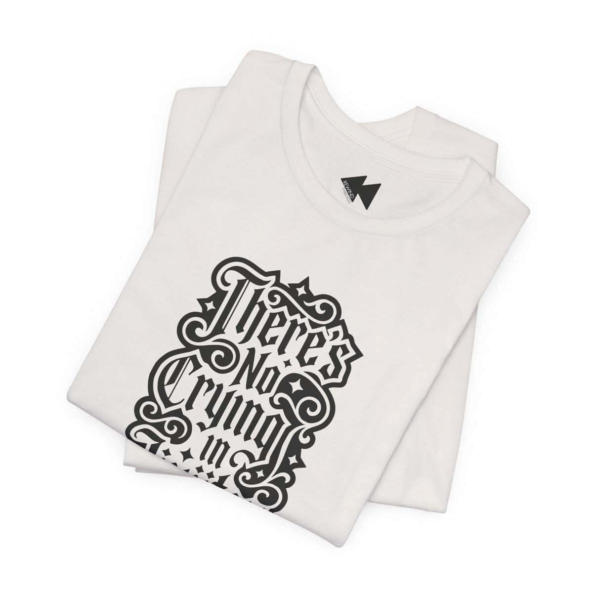 A folded light beige short-sleeve T-shirt with a black gothic-style graphic text print reading 'There's No Crying in JiuJitsu' on the front, displayed against a clean white background.