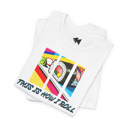 A folded white t-shirt with a colorful graphic of sushi and the text 'THIS IS HOW I ROLL' printed on the front, set against a plain white background.