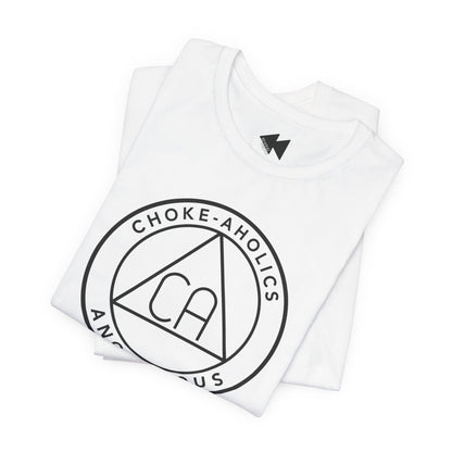 A folded white t-shirt with a black circular graphic on the front reading 'CHOKE-AHOLICS' around a triangle with 'CA' inside, shown on a plain white background.