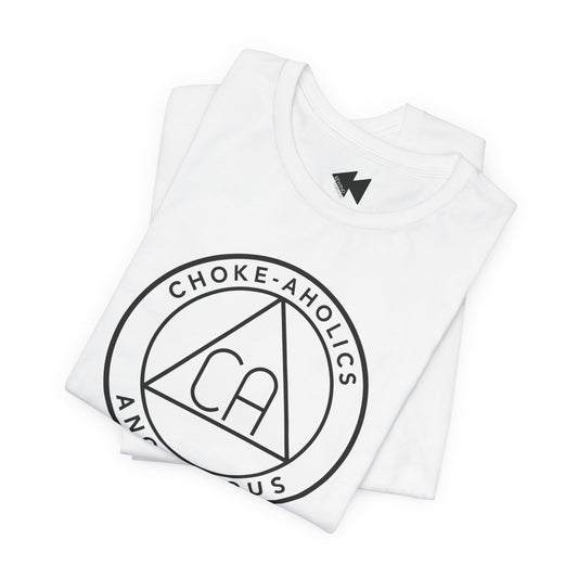 A folded white t-shirt with a black circular graphic on the front reading 'CHOKE-AHOLICS' around a triangle with 'CA' inside, shown on a plain white background.