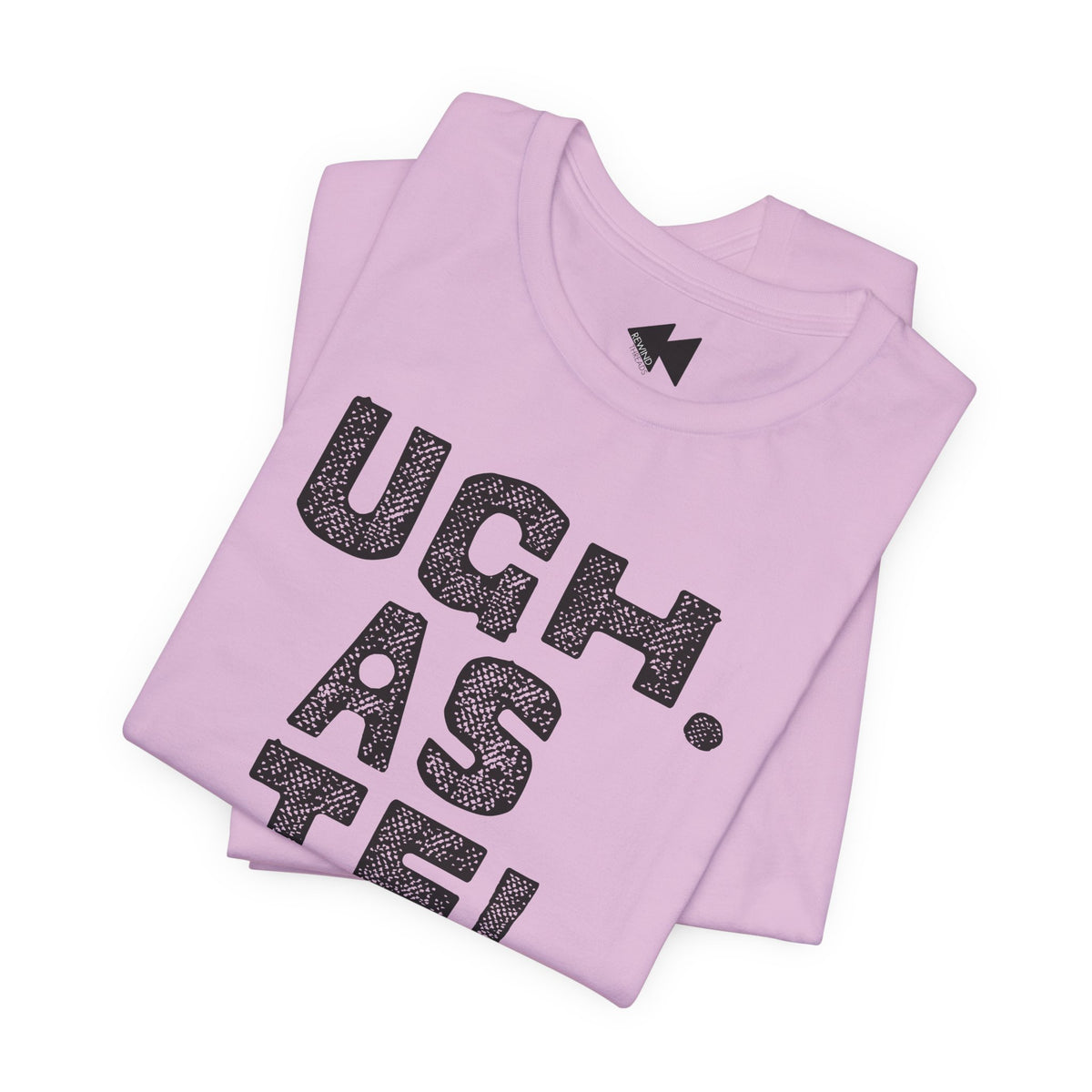 A folded light pink t-shirt with a black textured graphic reading 'UGH. AS IF'.
