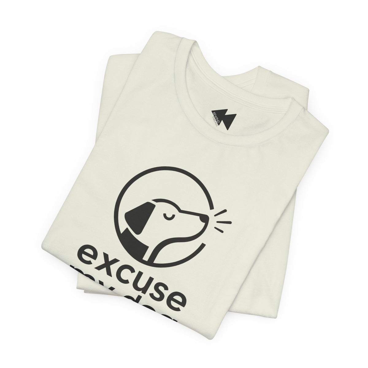 A folded off-white t-shirt with a black graphic of a dog inside a circle and the word 'excuse' printed below, shown on a clean white background.