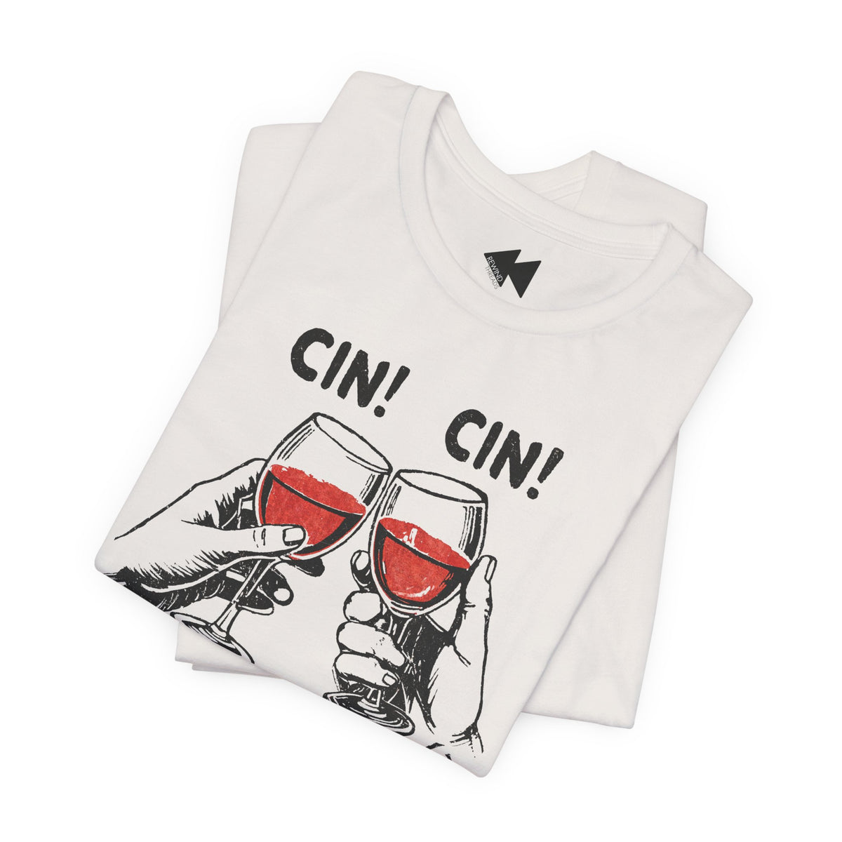 A folded white t-shirt featuring a graphic of two hands clinking wine glasses filled with red wine, with the text 'CIN! CIN!' printed above. A black geometric logo is visible inside the collar.