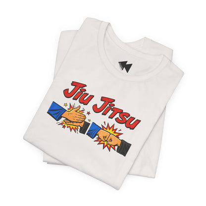 A folded light gray t-shirt featuring a 'Jiu Jitsu' graphic with two hands clashing in a comic-style illustration, displayed on a clean white background.