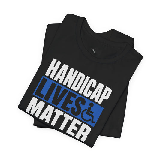 A black folded t-shirt with a graphic print that reads 'HANDICAP LIVES MATTER' in white and blue, featuring a wheelchair symbol, on a plain white background.