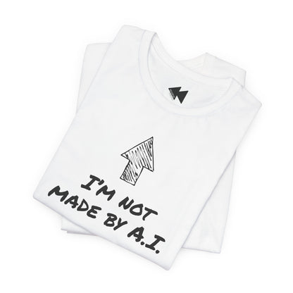A folded white t-shirt with a black hand-drawn arrow graphic and the text 'I'M NOT MADE BY A.I.