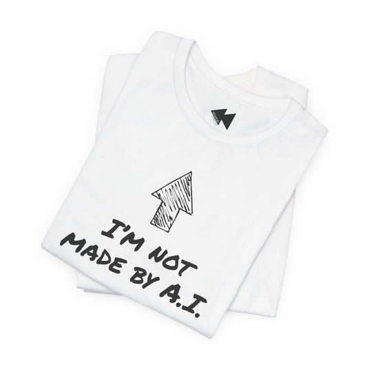 A folded white t-shirt with a black hand-drawn arrow graphic and the text 'I'M NOT MADE BY A.I.