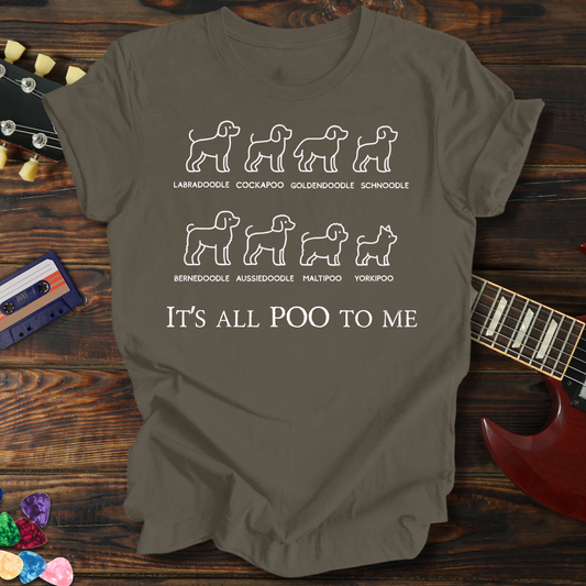 Brown t-shirt with dog breed illustrations and text on a wooden surface with a guitar and colorful objects.