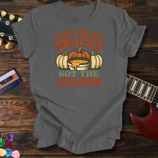 Gray t-shirt with pumpkin graphic and text on a wooden surface with guitar and cassette tape.