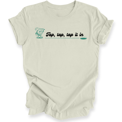 An off-white short-sleeve t-shirt with a graphic on the chest that reads 'Tap, tap, tap it in' in black script with a teal  outline and a small teal character. The shirt is shown against a plain white background with soft drop shadows.