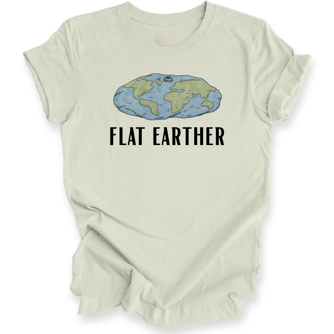 A light beige crewneck t-shirt with a graphic of a blue and green flat earth map and the text 'FLAT EARTHER' printed in black below it, displayed on a clean white background.