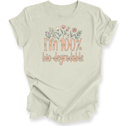 A light citron green t-shirt with a graphic print that reads 'I'm 100% bio-degradable' in peach-colored lettering, decorated with a small floral illustration above the text.