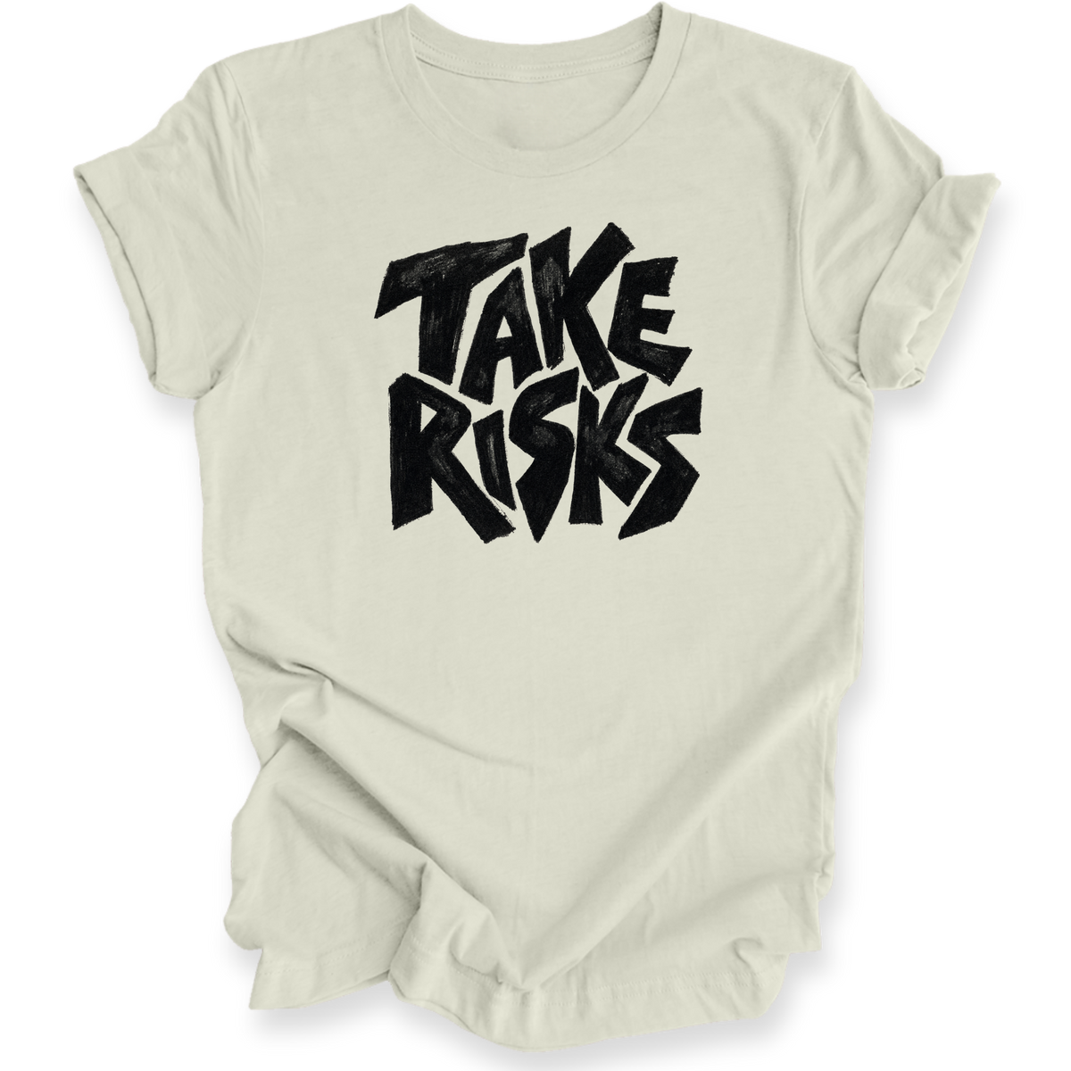 A light beige crewneck t-shirt with a bold black graphic text reading 'TAKE RISKS' in a stylized, slightly distressed font, displayed on a clean white background.