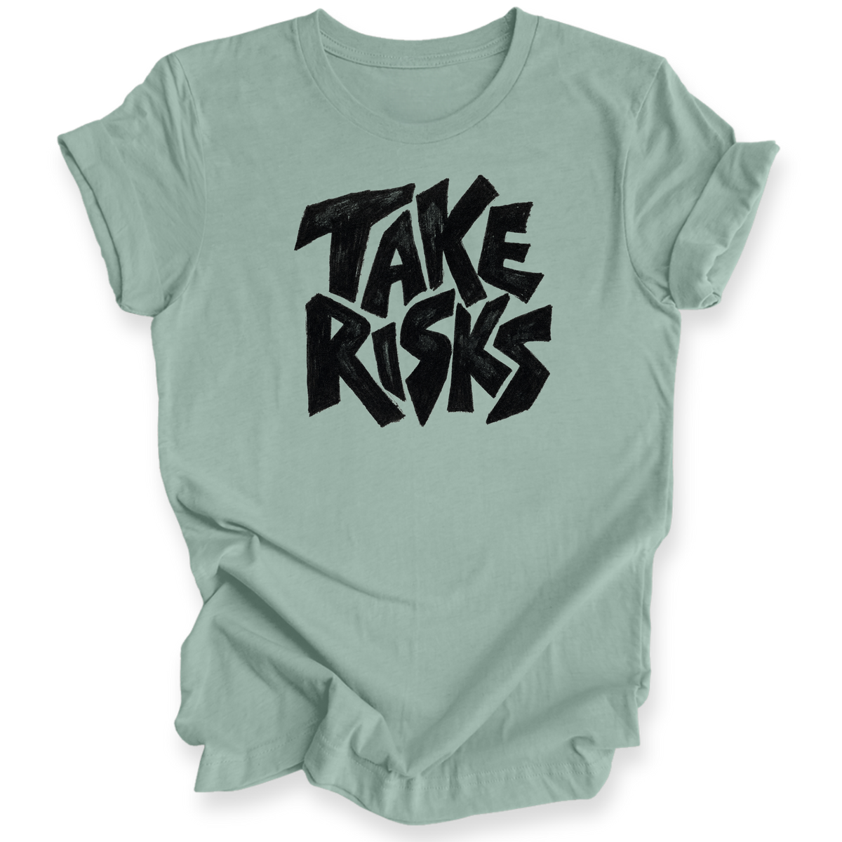 A sage green short-sleeve t-shirt with a black graphic text print reading 'TAKE RISKS' in a stylized, bold font, displayed on a clean white background.