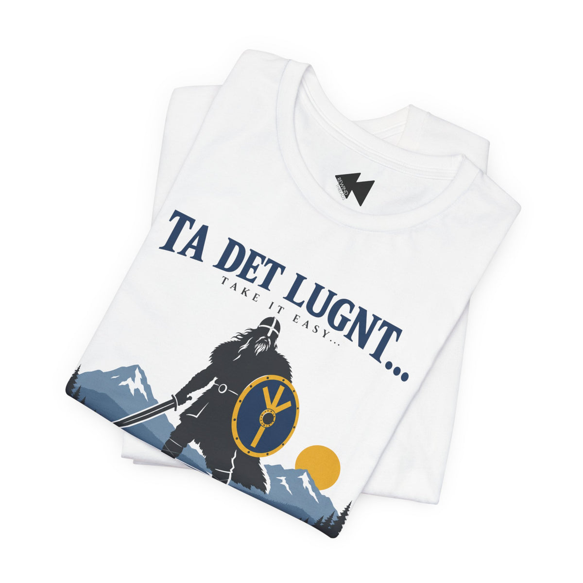 A folded white t-shirt with a Viking-themed graphic print featuring a silhouette of a warrior with a shield, mountains, and the text 'TA DET LUGNT.