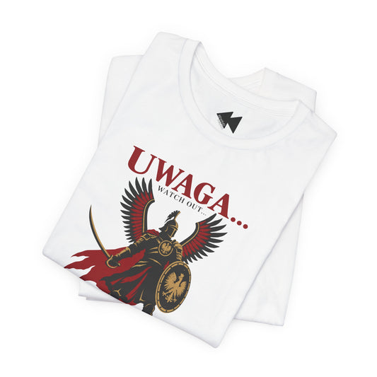 A folded white short-sleeve T-shirt with a graphic print of a winged gladiator holding a shield and sword, with the text 'UWAGA.