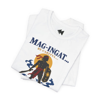A folded white short-sleeve T-shirt with a graphic print on the front. The print features the text 'MAG-INGAT.