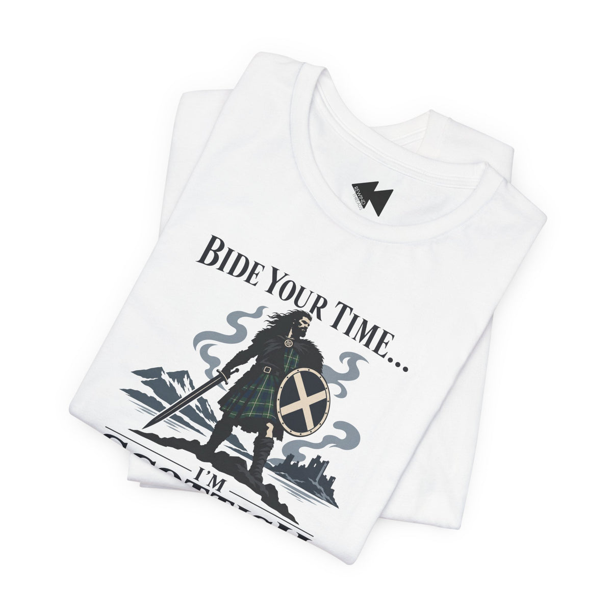 A folded white t-shirt with a graphic print of a Scottish warrior in a tartan kilt holding a sword and shield, with the text 'BIDE YOUR TIME.