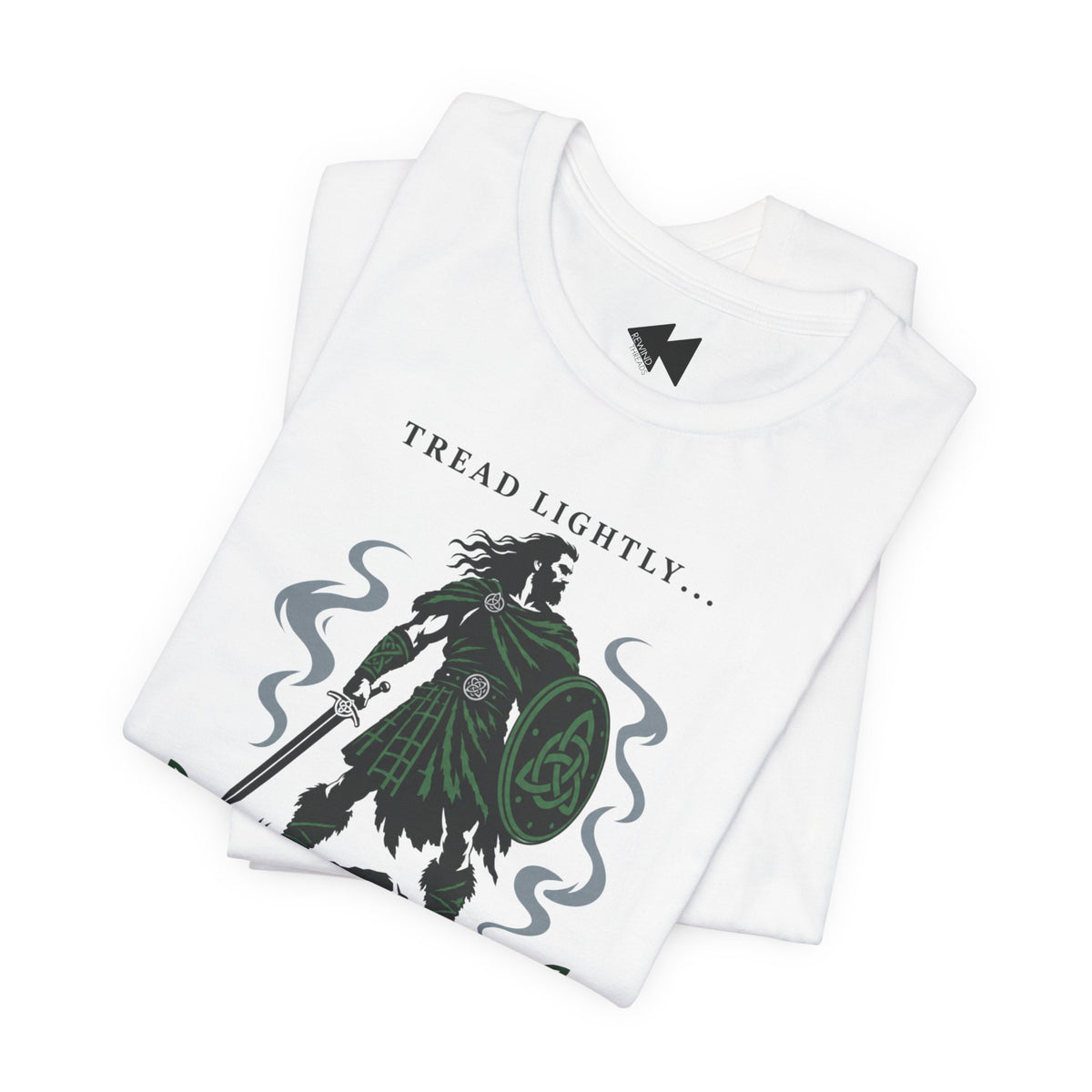 A folded white crewneck t-shirt with a graphic print of a Irish tartan warrior holding a shield and sword, accompanied by the text 'Tread lightly I'm Irish".
