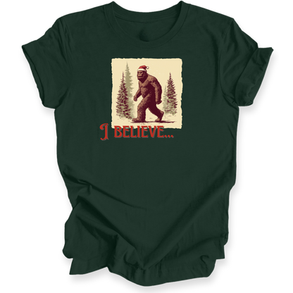 Dark green t-shirt with a graphic of a bear wearing a Santa hat and the text 'I BELIEVE...' on a white background.