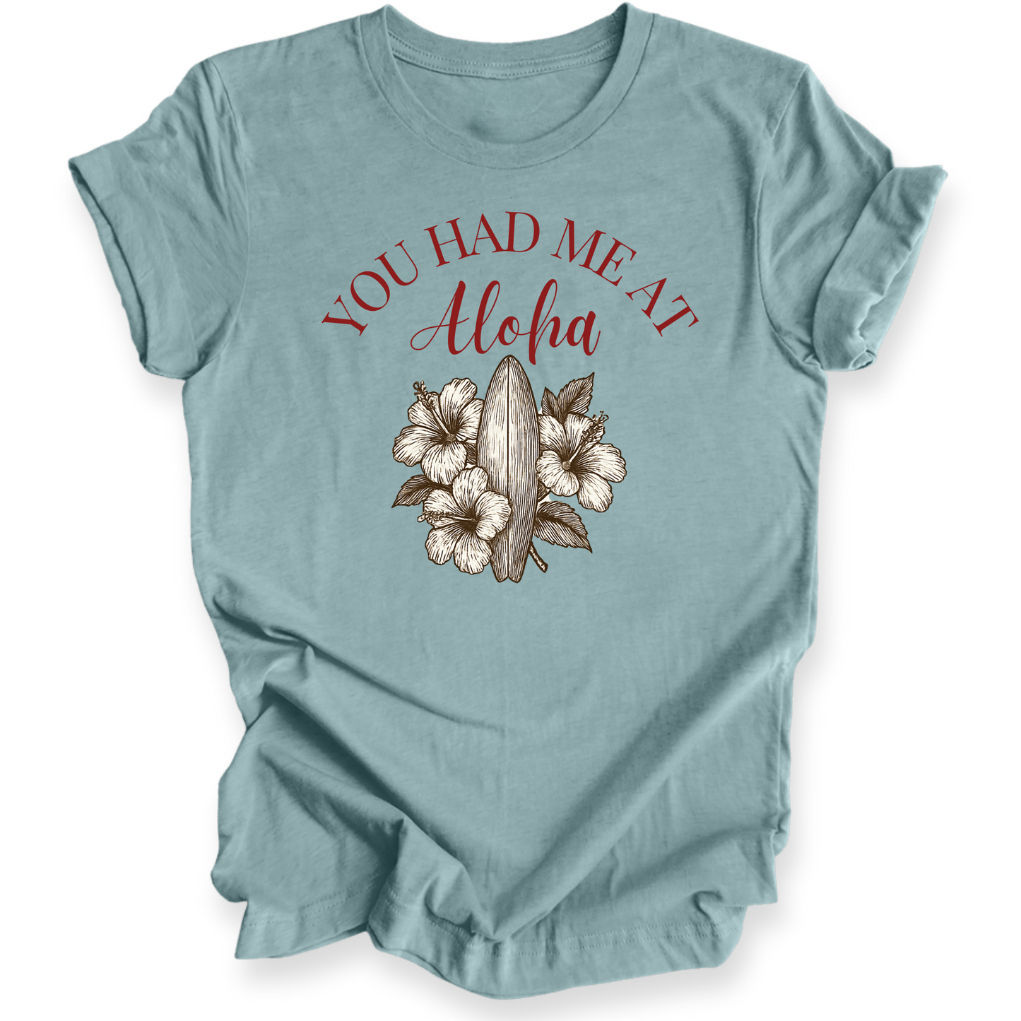 Light blue t-shirt with 'You Had Me at Aloha' text and floral design on a white background