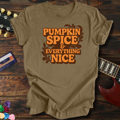 Beige t-shirt with 'Pumpkin Spice & Everything Nice' text on a wooden surface with a guitar and cassette tape.