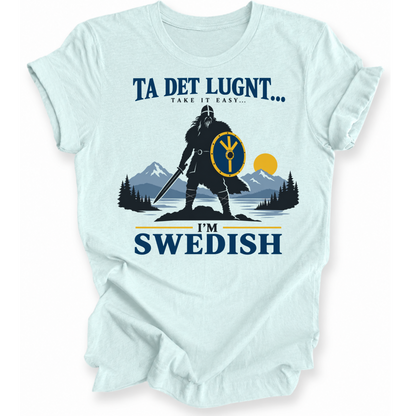 A light blue short-sleeve t-shirt with a graphic print of a Viking warrior, mountains, pine trees, and the text 'TA DET LUGNT.