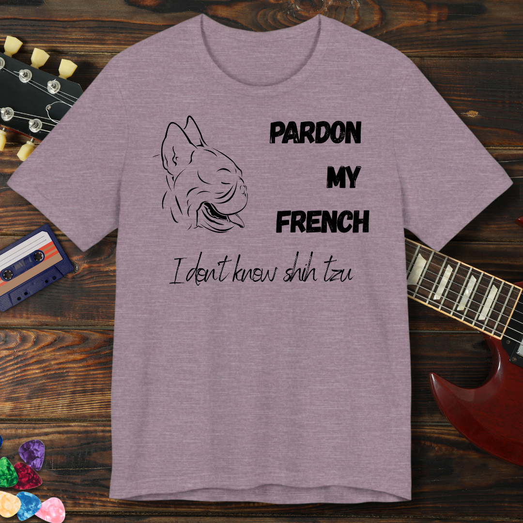 Purple t-shirt with dog graphic and text on a wooden surface with guitar and cassette tape.