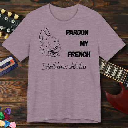Purple t-shirt with dog graphic and text on a wooden surface with guitar and cassette tape.