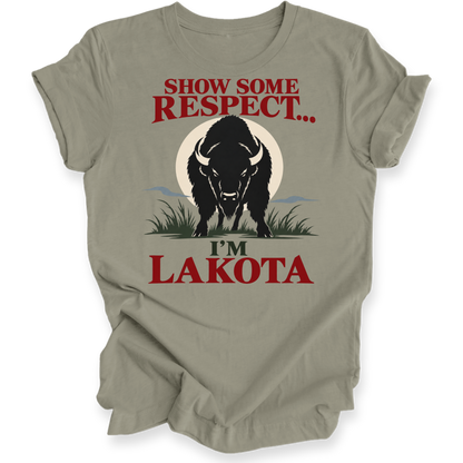 A beige graphic t-shirt featuring a black bison illustration and the text 'SHOW SOME RESPECT I'M LAKOTA