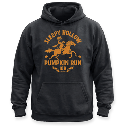 A black pullover hoodie with a distressed orange graphic on the chest reading 'SLEEPY HOLLOW PUMPKIN RUN 10K' featuring an illustration of a person riding a horse and a pumpkin. The hoodie is shown against a plain white background.