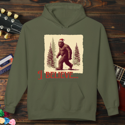Green hoodie with a Sasquatch graphic and 'I Believe' text on a wooden background