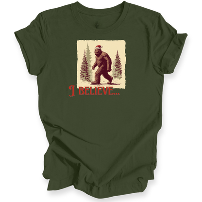 Green t-shirt with a graphic of a bear wearing a Santa hat and 'I Believe' text on a white background