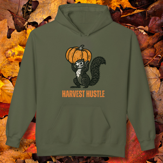 Green hoodie with a skunk and pumpkin design on a background of autumn leaves